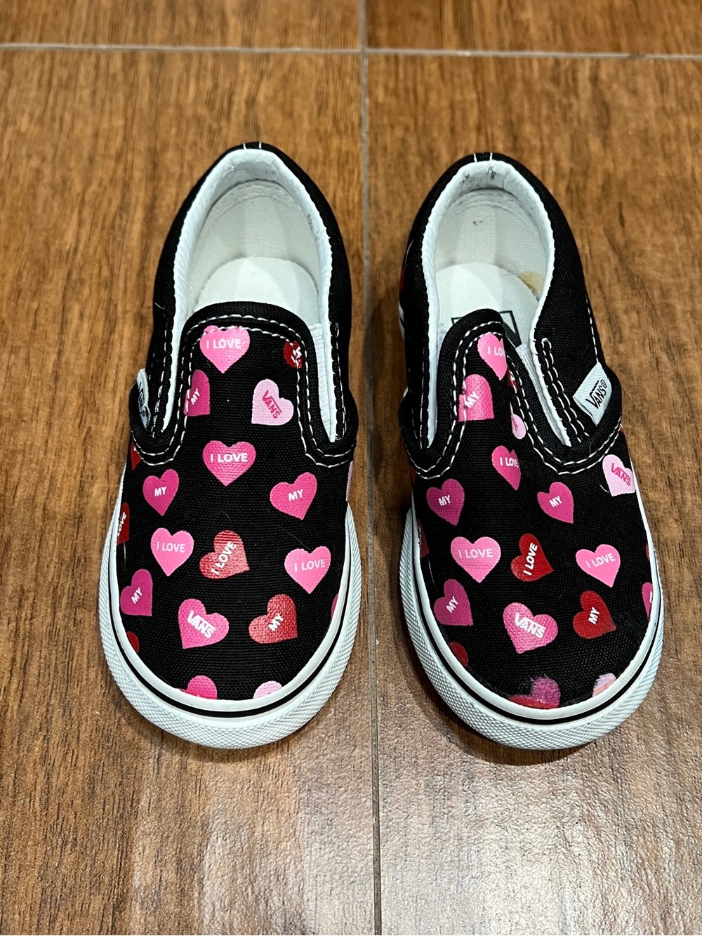 Vans Kids Slip-On Sneakers in Black with Pink & Red Heart Print